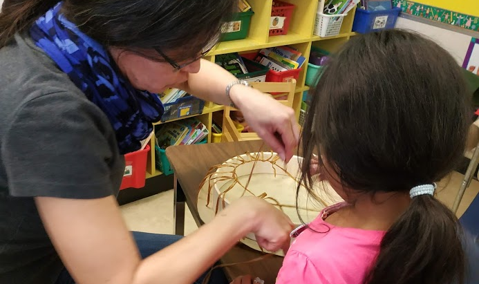 QA students learning to make drums after learning important Indigenous protocols.