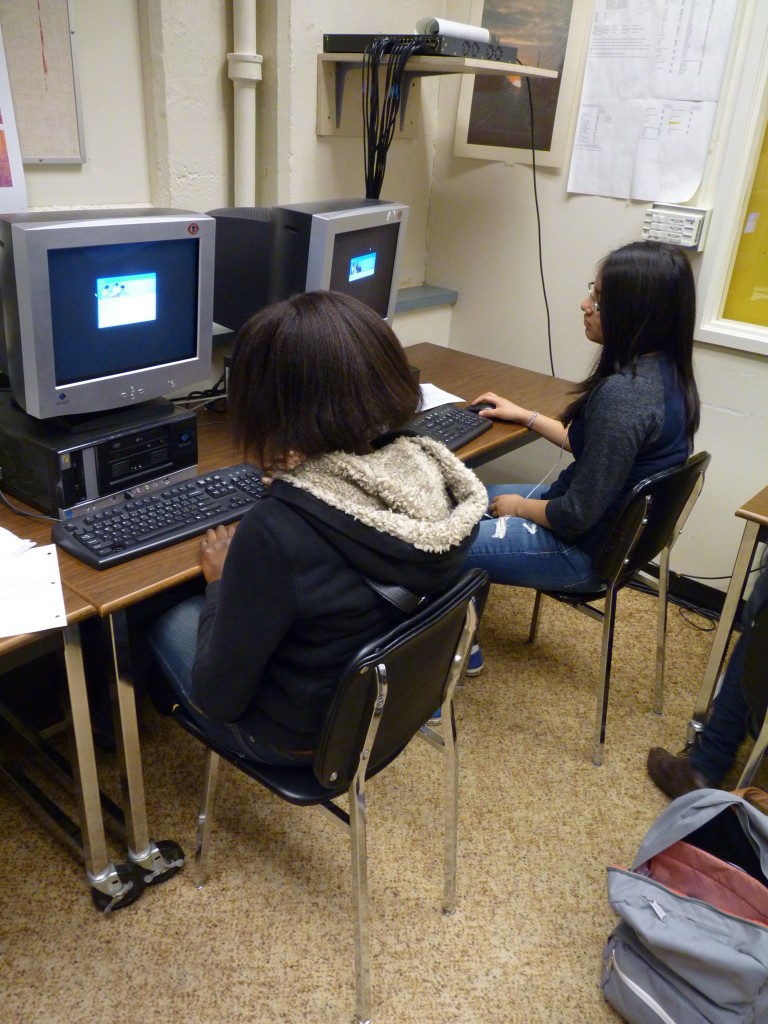 Britannia students wait for their computers to turn on.